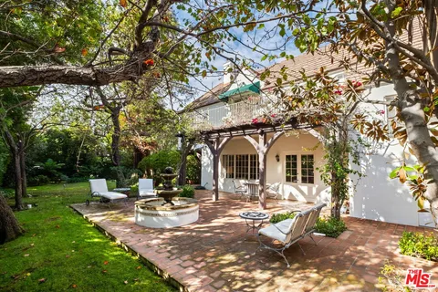 a view of a house with backyard porch and sitting area
