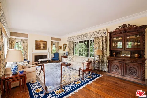 a living room with furniture a fireplace and a table