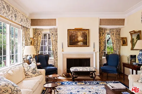 a living room with furniture wooden floor and a fireplace
