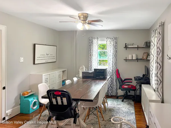 a large kitchen with a window a sink and cabinets