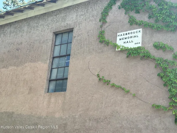 a room with furniture a flat screen tv and a window