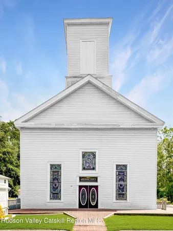 a front view of a house with stairs