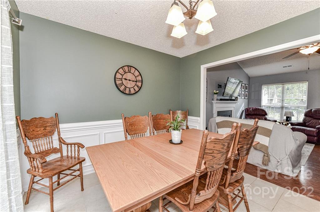 2215 Genesis Drive Monroe, NC 28110 - Photo 14 of 29 a view of a dining room with furniture and a chandelier fan