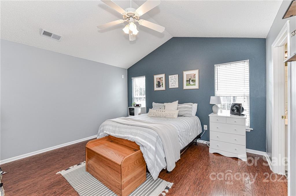 2215 Genesis Drive Monroe, NC 28110 - Photo 16 of 29 a bedroom with a large bed and a chandelier