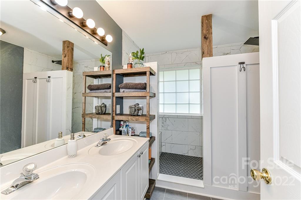 2215 Genesis Drive Monroe, NC 28110 - Photo 17 of 29 a en suite bathroom with a sink and a large mirror