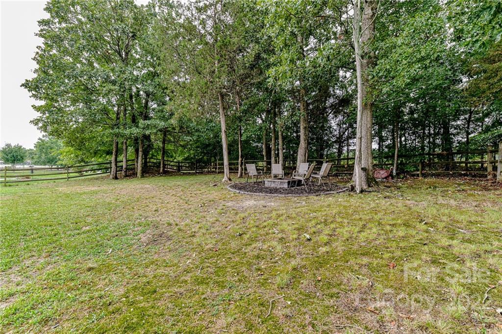 2215 Genesis Drive Monroe, NC 28110 - Photo 25 of 29 a view of outdoor space with deck and trees