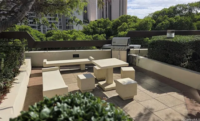 a view of a chairs and table in the backyard