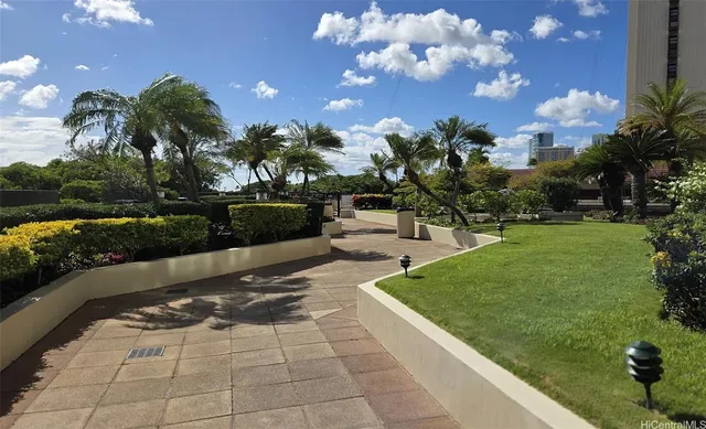 a view of a fountain in front of a house with a yard