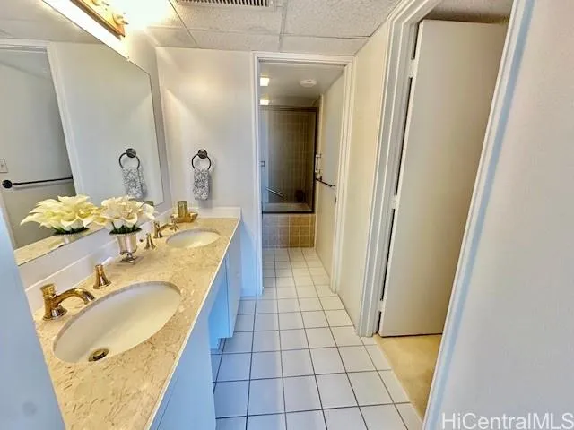 a bathroom with a granite countertop sink and a mirror