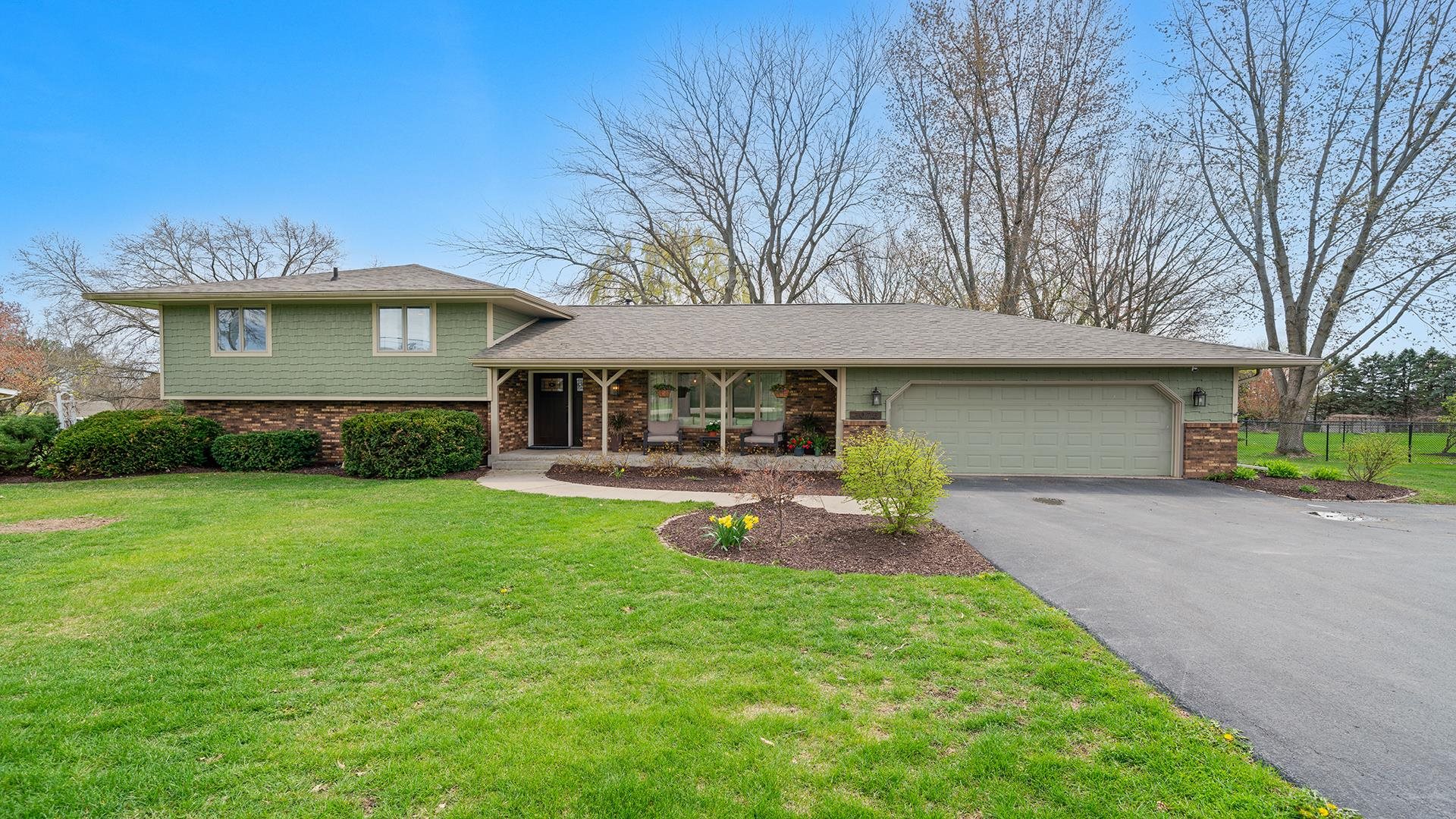3075 East Water Road Byron, IL 61010 - Photo 1 of 46 a view of a house with a yard porch and sitting area