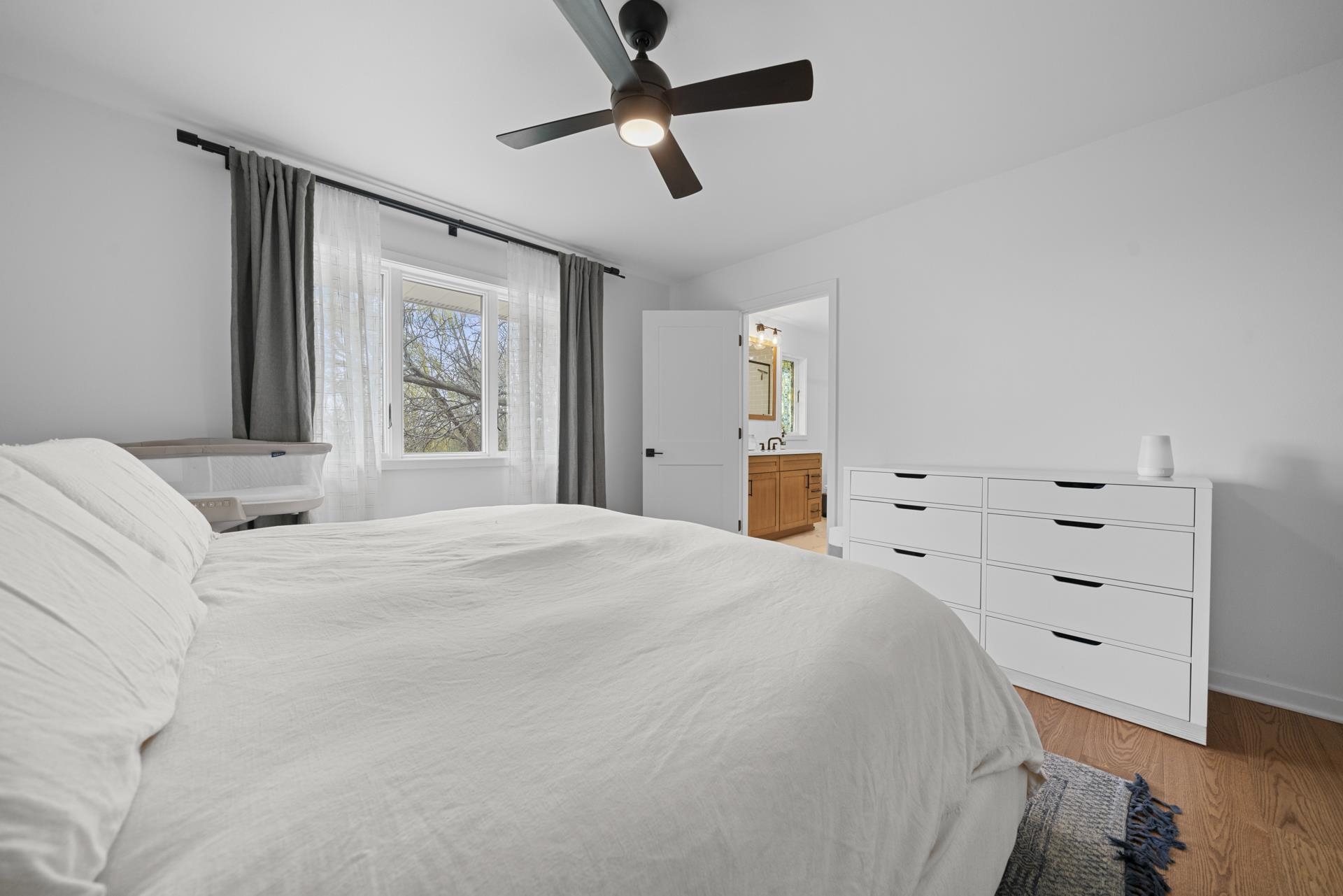 3075 East Water Road Byron, IL 61010 - Photo 20 of 46 a bedroom with a bed and a chandelier