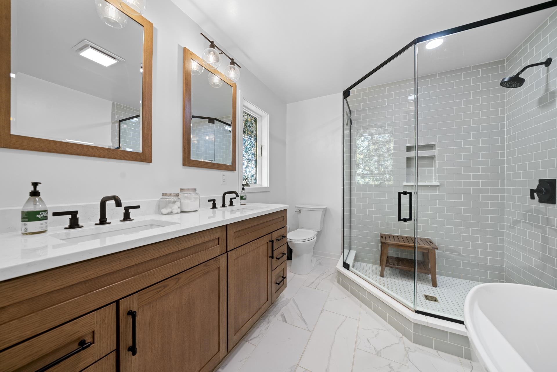 3075 East Water Road Byron, IL 61010 - Photo 21 of 46 a spacious bathroom with a double vanity sink a toilet a mirror and shower