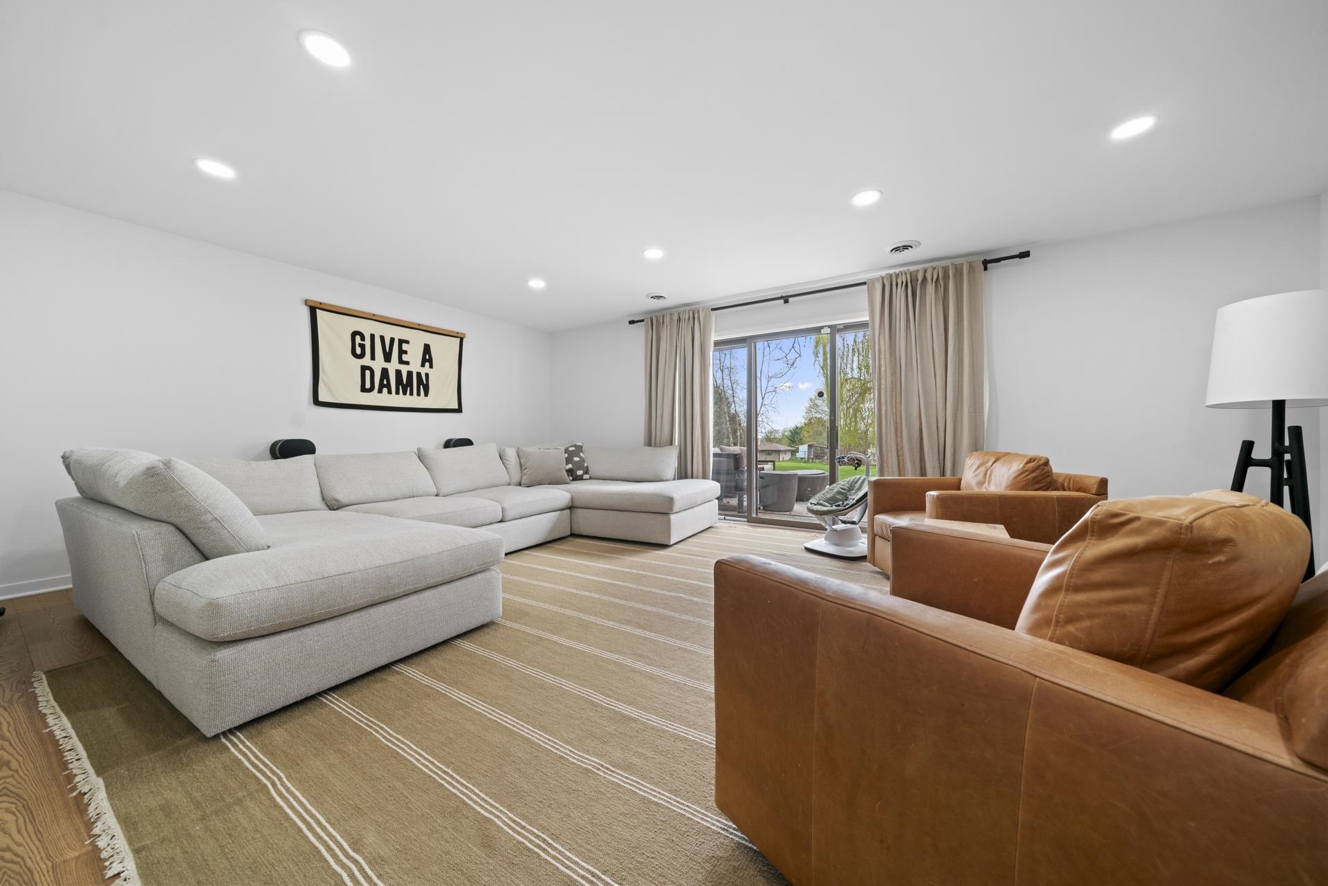 3075 East Water Road Byron, IL 61010 - Photo 27 of 46 a living room with furniture and a large window