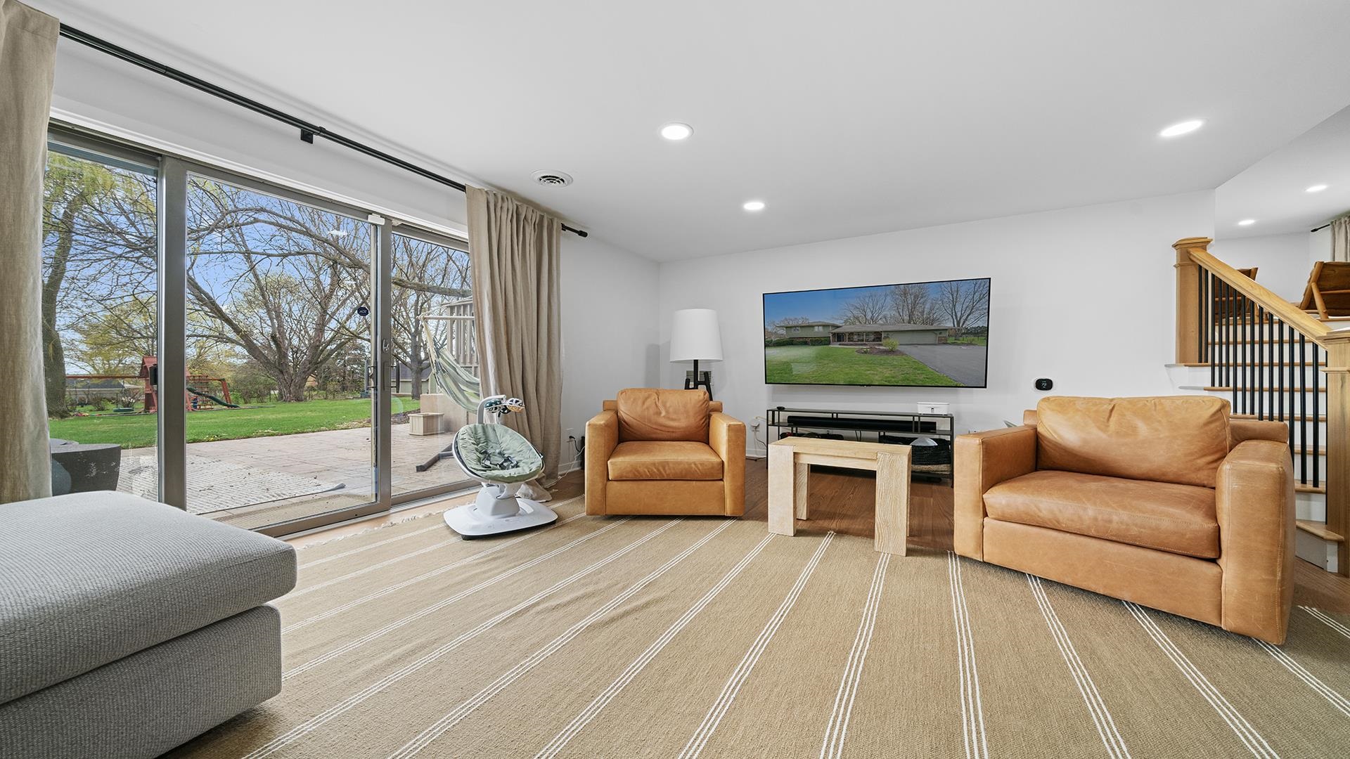 3075 East Water Road Byron, IL 61010 - Photo 28 of 46 a living room with furniture and a flat screen tv