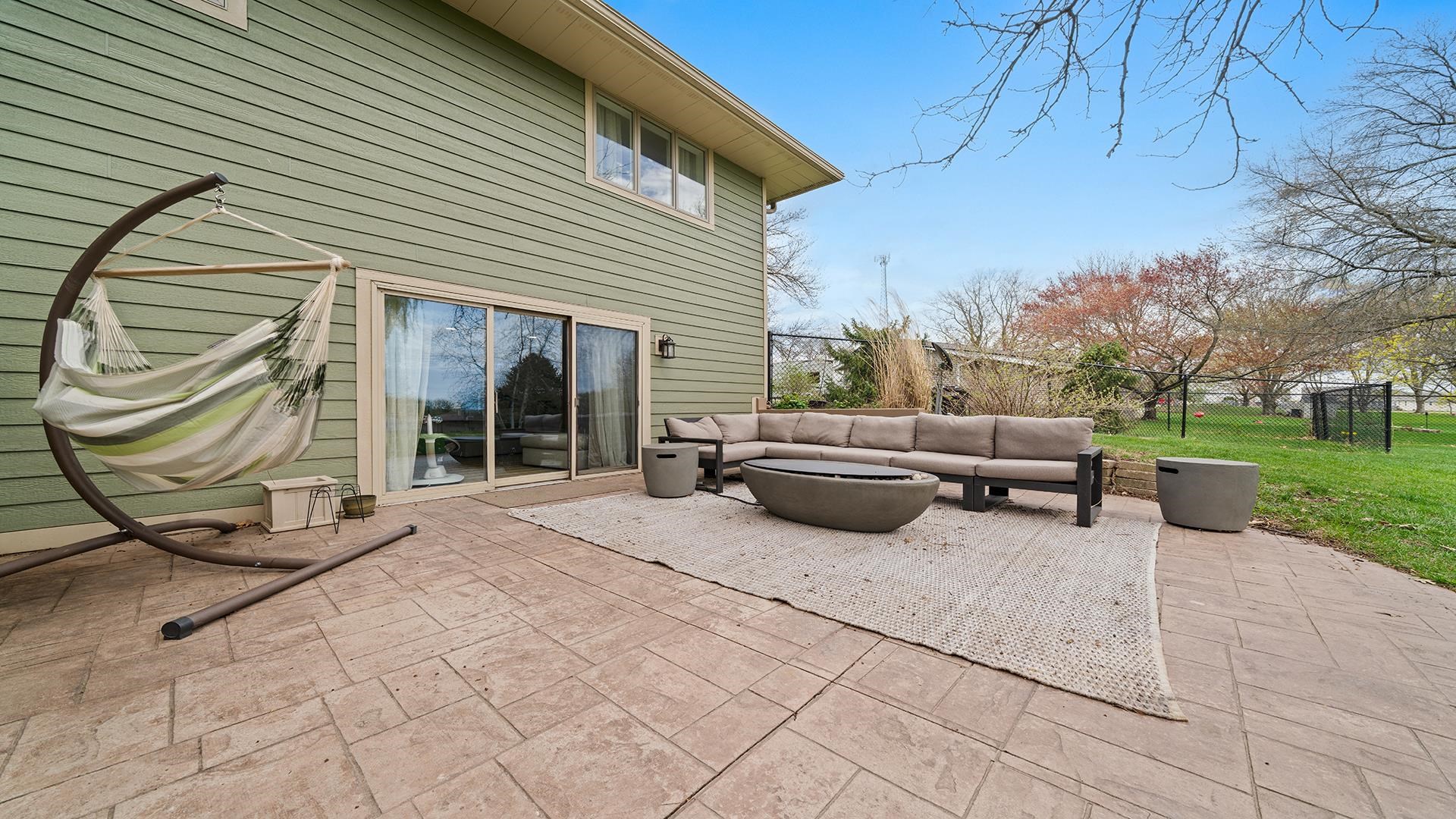 3075 East Water Road Byron, IL 61010 - Photo 38 of 46 a view of a patio with table and chairs and potted plants