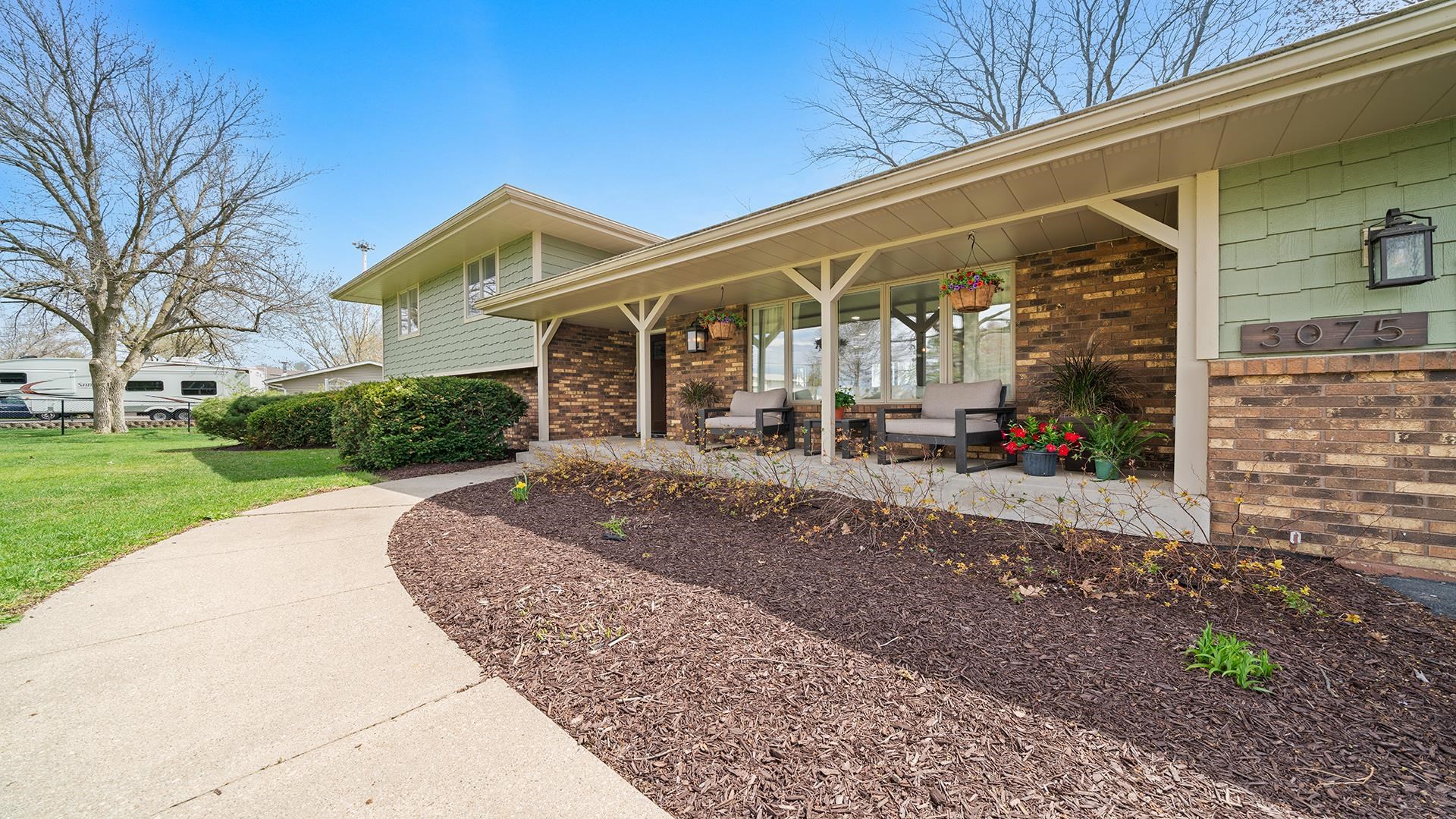 3075 East Water Road Byron, IL 61010 - Photo 43 of 46 a front view of a house with garden