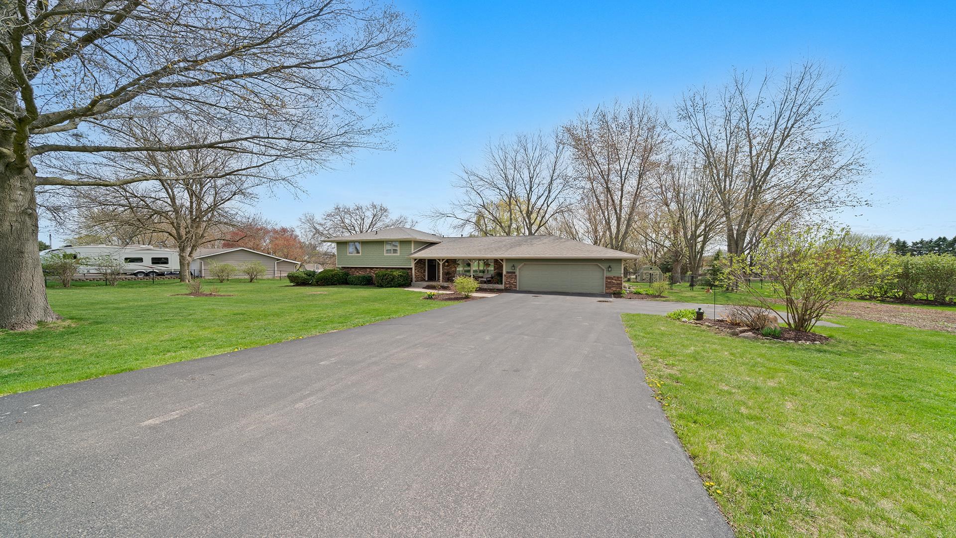 3075 East Water Road Byron, IL 61010 - Photo 44 of 46 a front view of a house with garden