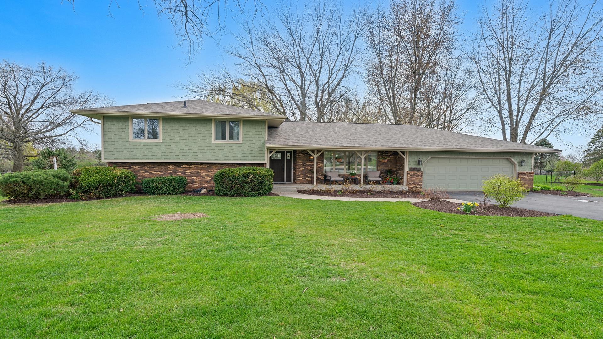 3075 East Water Road Byron, IL 61010 - Photo 45 of 46 a front view of a house with garden