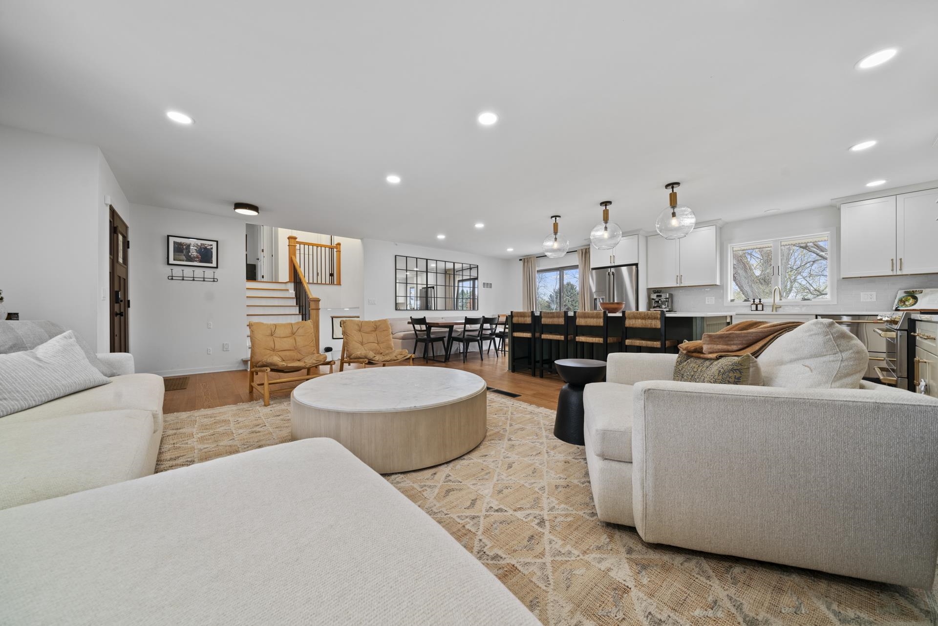 3075 East Water Road Byron, IL 61010 - Photo 7 of 46 a living room with furniture and a dining table with kitchen view