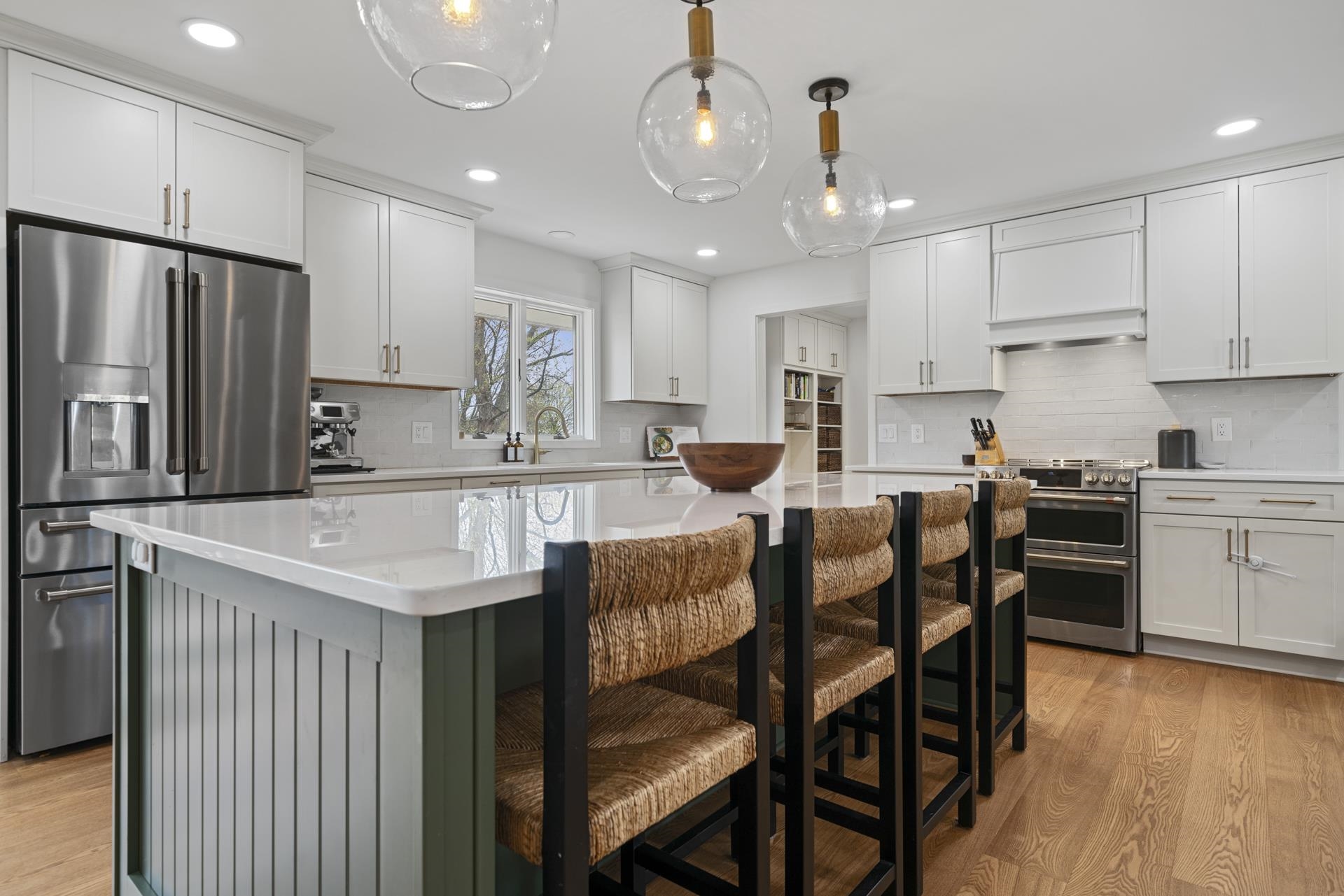 3075 East Water Road Byron, IL 61010 - Photo 10 of 46 a kitchen with granite countertop a table chairs stove microwave and cabinets