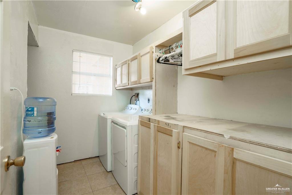 15 El Mesquite Lane Rio Grande City, TX 78582 - Photo 13 of 30 a utility room with cabinets washer and dryer