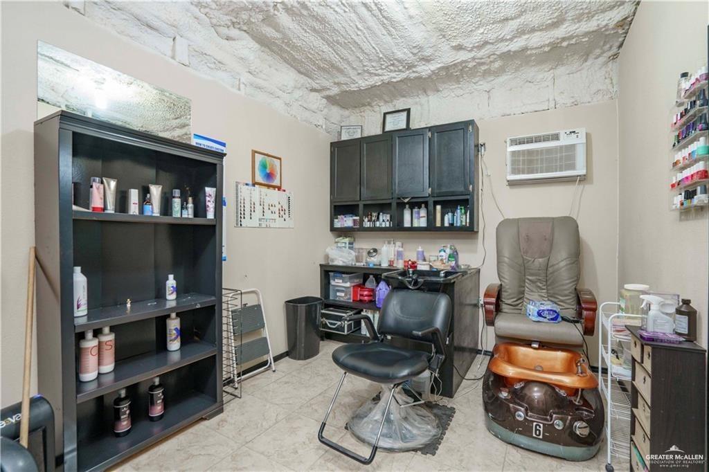 15 El Mesquite Lane Rio Grande City, TX 78582 - Photo 18 of 30 a room with a workspace and a couch