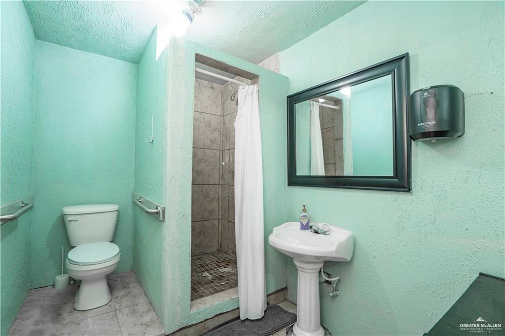 15 El Mesquite Lane Rio Grande City, TX 78582 - Photo 20 of 30 a bathroom with a toilet sink and mirror