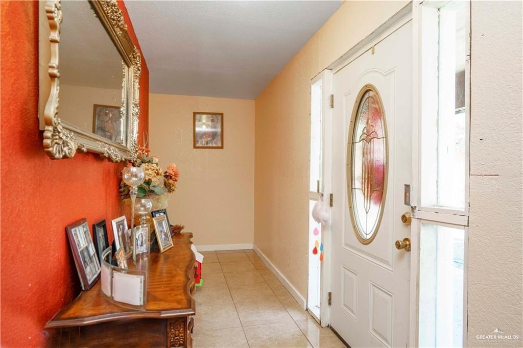 15 El Mesquite Lane Rio Grande City, TX 78582 - Photo 2 of 30 a view of a hallway with wooden floor and windows