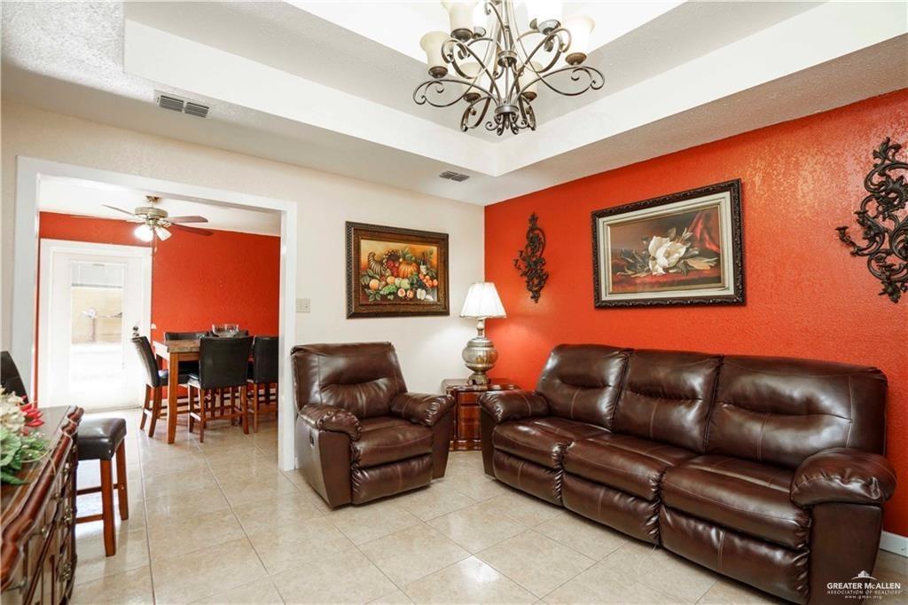 15 El Mesquite Lane Rio Grande City, TX 78582 - Photo 3 of 30 a living room with furniture a dining table and a bookshelf