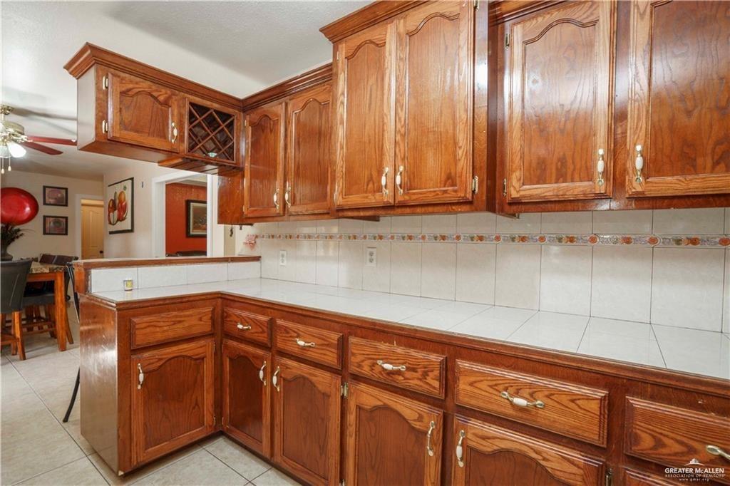15 El Mesquite Lane Rio Grande City, TX 78582 - Photo 7 of 30 a kitchen with stainless steel appliances granite countertop a sink and cabinets