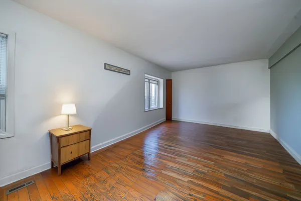 a view of room with hardwood floor and cabinet