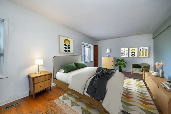 a bedroom with a bed and wooden floor
