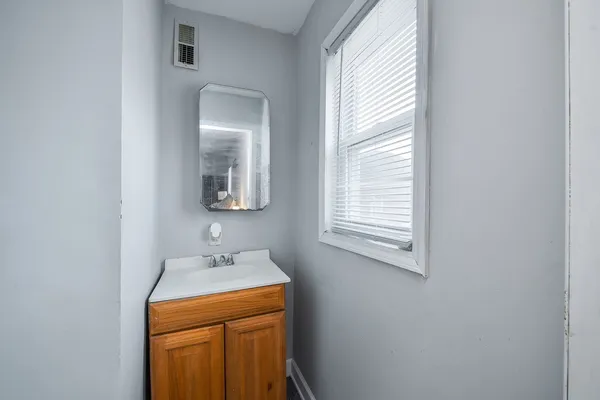 a bathroom with a sink a mirror and vanity
