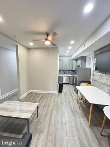 a view of kitchen with sink microwave and refrigerator