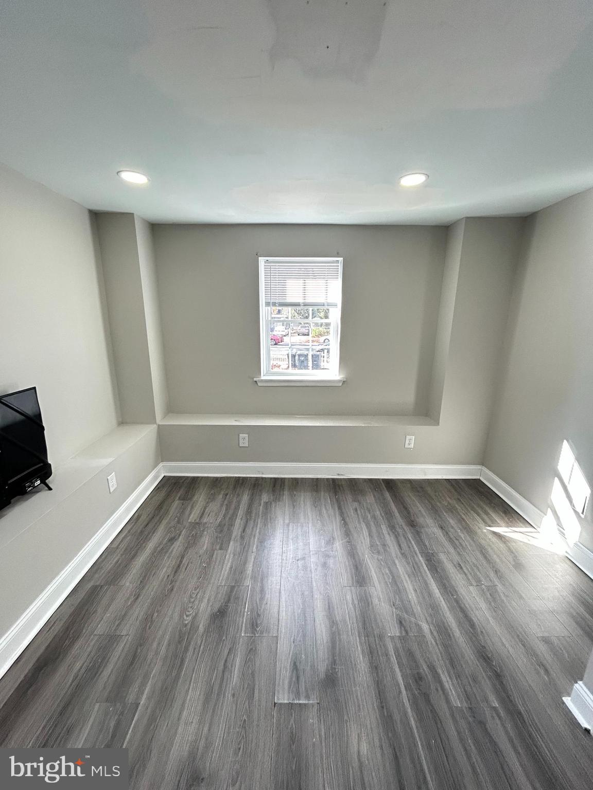 2417 North 54th Street, Unit A Philadelphia, PA 19131 - Photo 6 of 13 wooden floor in an empty room with a window