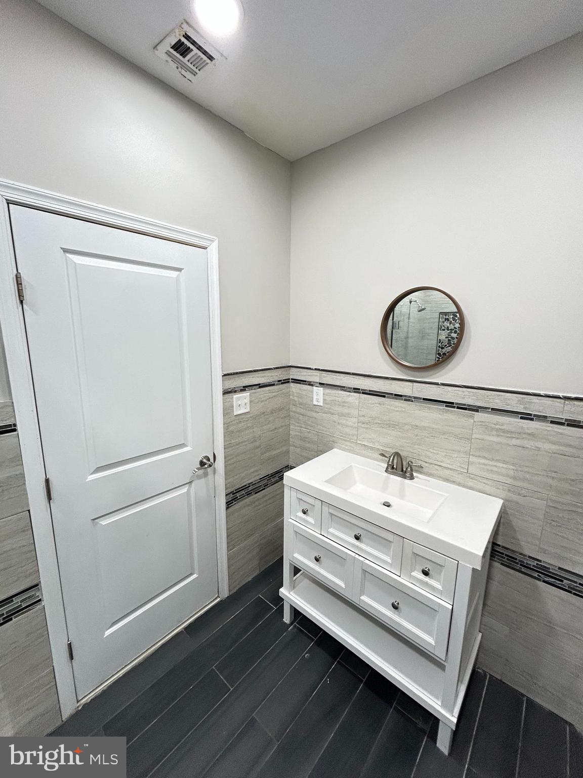 2417 North 54th Street, Unit A Philadelphia, PA 19131 - Photo 9 of 13 a bathroom with a sink and a mirror