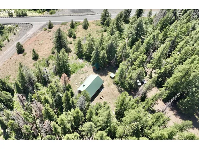 an aerial view of a house with a yard and lake view