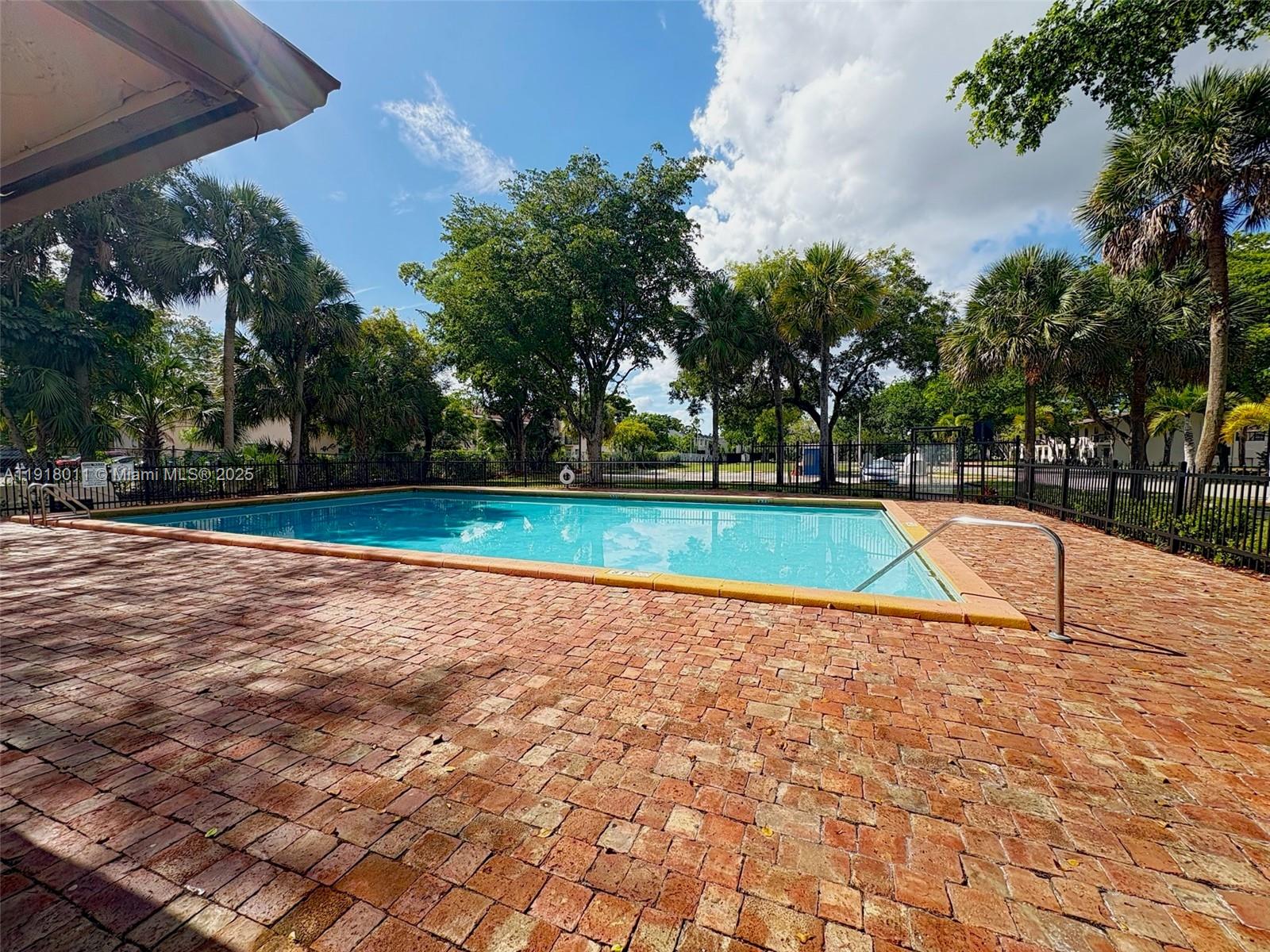 4022 Lakeside Drive, Unit 4022 Tamarac, FL 33319 - Photo 1 of 13 a view of a swimming pool with an outdoor space
