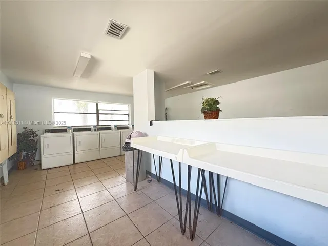 a room with a washing machine and a stove top oven