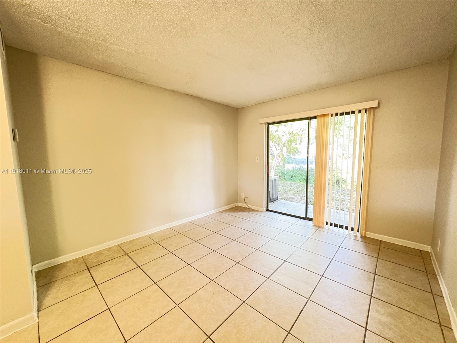 4022 Lakeside Drive, Unit 4022 Tamarac, FL 33319 - Photo 6 of 13 a view of an empty room and window