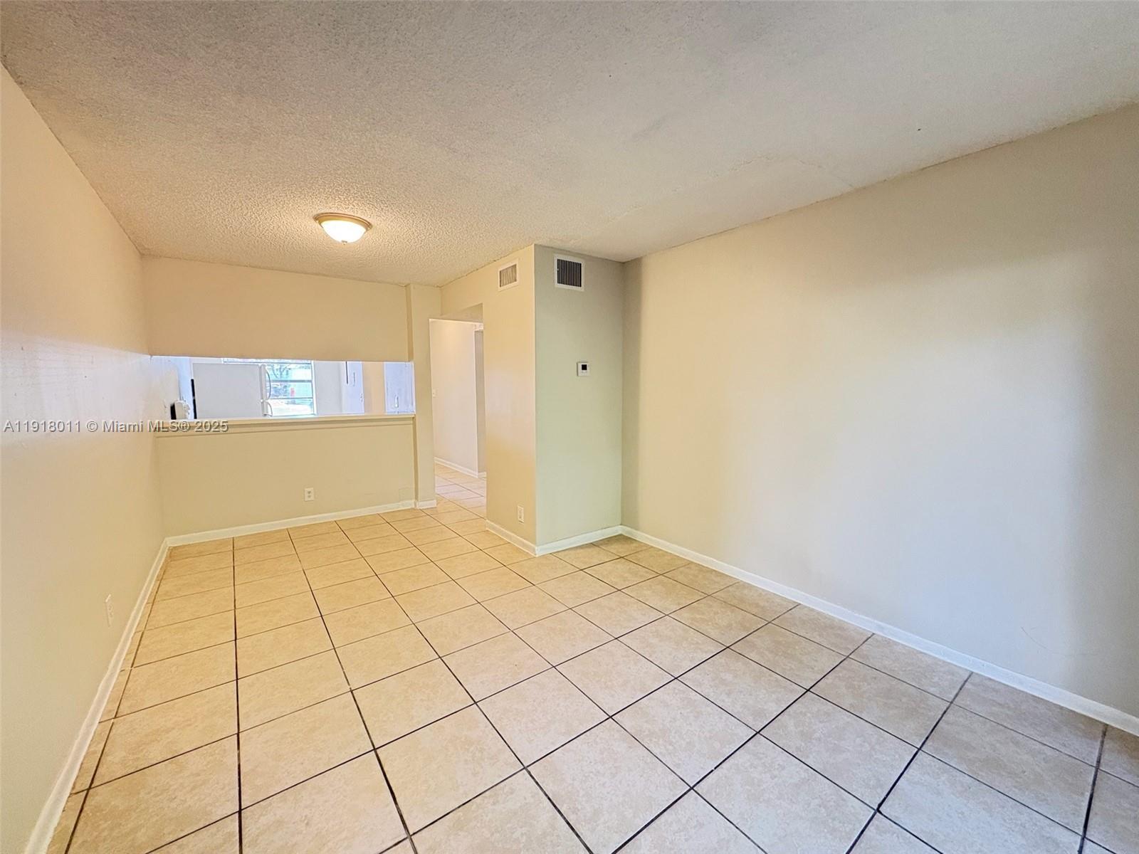 4022 Lakeside Drive, Unit 4022 Tamarac, FL 33319 - Photo 7 of 13 a view of an empty room and window