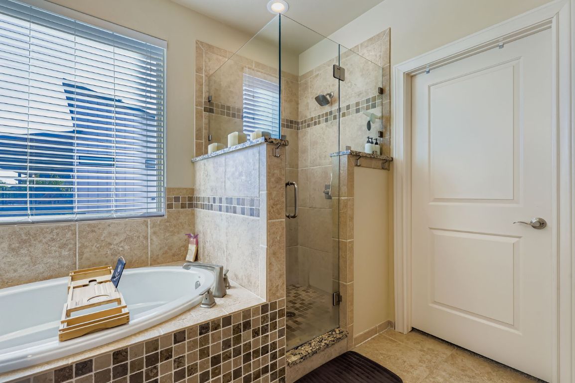19004 Mariners Point Lago Vista, TX 78645 - Photo 10 of 23 a bathroom with a tub shower and sink