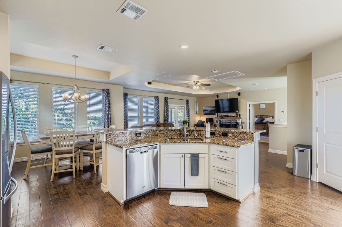 19004 Mariners Point Lago Vista, TX 78645 - Photo 23 of 23 a kitchen with stainless steel appliances granite countertop a stove and cabinets