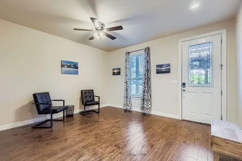 a living room with furniture ceiling fan and a rug