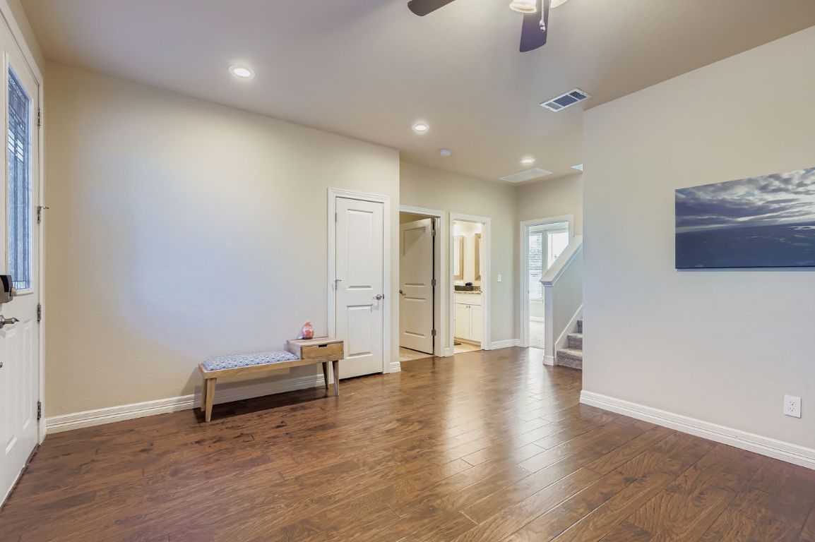 19004 Mariners Point Lago Vista, TX 78645 - Photo 5 of 23 an empty room with wooden floor and ceiling fan