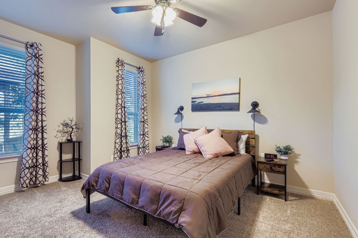 19004 Mariners Point Lago Vista, TX 78645 - Photo 6 of 23 a bedroom with a bed and a chandelier