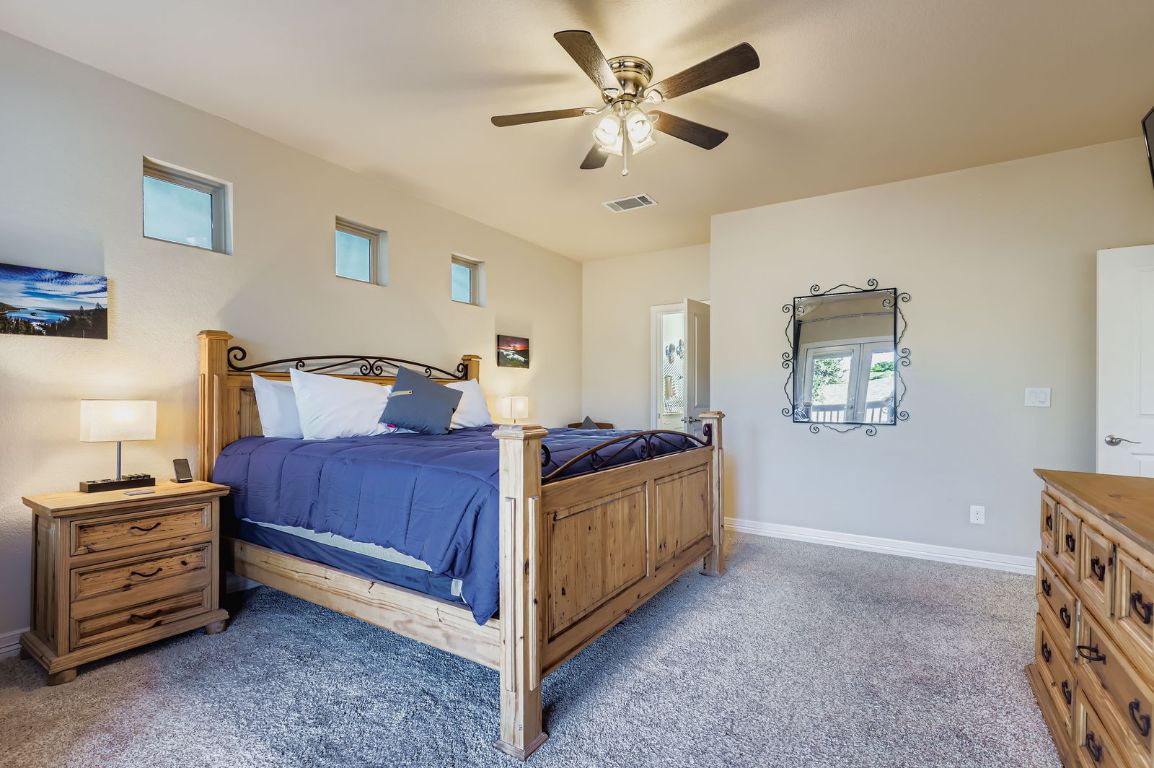 19004 Mariners Point Lago Vista, TX 78645 - Photo 8 of 23 a bedroom with a bed and a chandelier