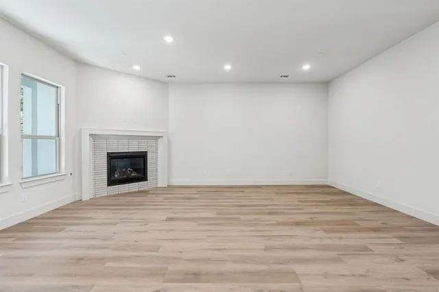 a view of a kitchen with wooden floor and electronic appliances