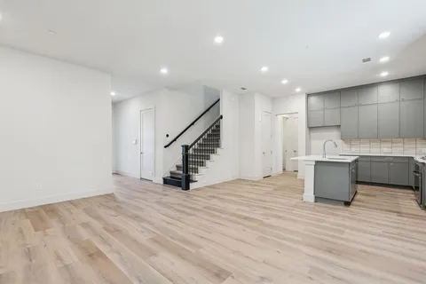 a kitchen with kitchen island a sink appliances and cabinets