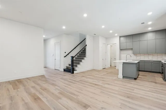 a kitchen with kitchen island a sink appliances and cabinets